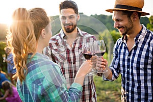 Wine tourists tasting wine in vineyard