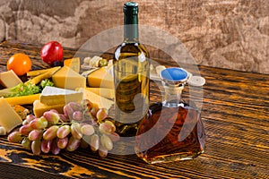 Wine and Whiskey on Table with Cheese and Grapes