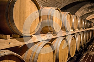 Wine in wooden barrels is stored. Wine cellar.