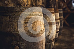 Wine in wooden barrels is stored. Wine cellar.