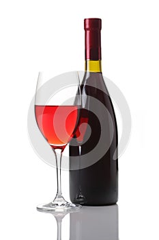 Wineglass and bottle of red wine isolated on white