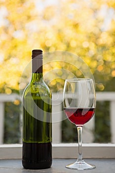 Wineglass and bottle on table