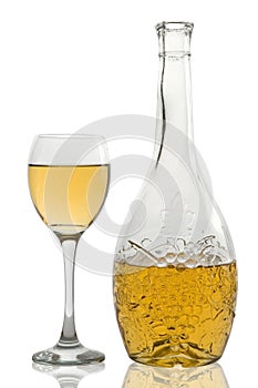 Wineglass and bottle with white wine