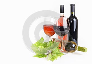 Wineglass, bottle of wine and grapes leaf