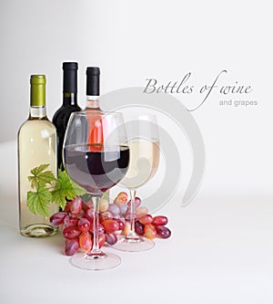 Wineglass, bottles of wine, grapes