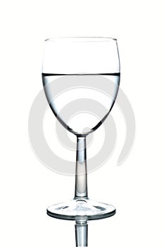 Wineglass half-full of water isolated on white