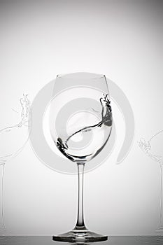 Wineglass with splashing liquid