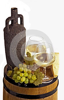 Wineglass with white wine and bottle