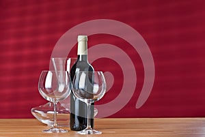Wineglasses with bottle and carafe on the table. photo