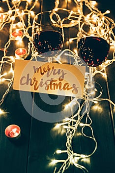 Wineglasses and merry christmas card