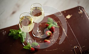 Wineglasses with white wine decorated with strawberry and mint