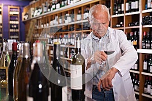 Winemaker checking wine in store