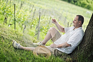 Winemaker drinks white wine