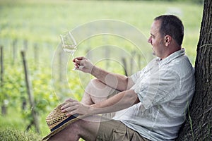 Winemaker drinks white wine