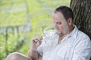 Winemaker drinks white wine