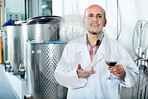 Winemaker examining sample of wine