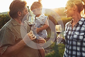 Winemaker family together in vineyard