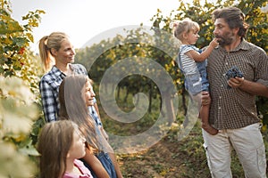 Winemaker family together in vineyard