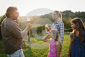 Winemaker family together in vineyard