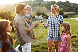 Winemaker family together in vineyard