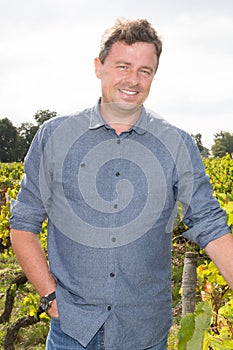 winemaker man standing at vineyard on sunny day