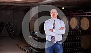 Winemaker standing in wine cellar