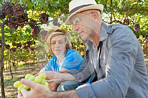 Winemakers father and son in vineyard