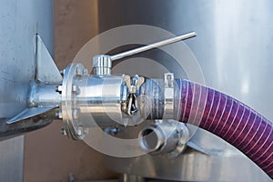 Winemaking crushed grapes pumped into tank photo