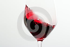 Glass of red wine, pouring drink at luxury holiday tasting event, quality control splashing liquid motion background for oenology photo
