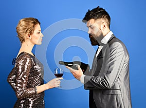 Winetasting and celebrating concept. Man with beard, woman in dress