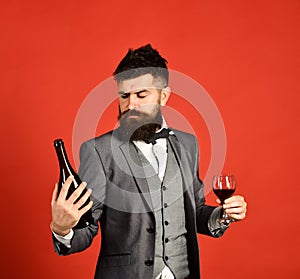 Winetasting and degustation concept. Man holding glass of cabernet photo