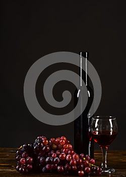 Winetasting and degustation still life concept. Grapes, bottle and wineglass