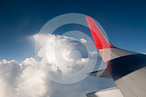 Wing aircraft against the blue sky and clouds