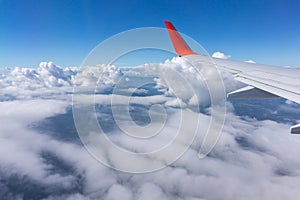 The wing aircraft in altitude during flight over the cloud.