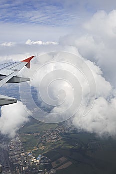 Wing aircraft and cumulus clouds in the sky above