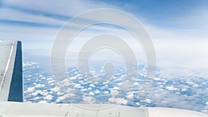 wing of aircraft and view of clouds over land