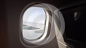 The wing of the aircraft in the window. window with seats on the plane. the cabin of the aircraft. passenger air travel