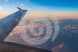 Wing of airplane above clouds