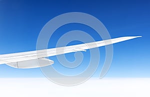 Wing of an airplane on blue sky