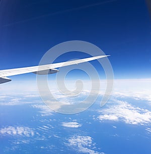 Wing of an airplane on blue sky