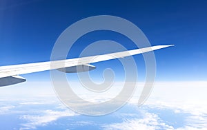 Wing of an airplane on blue sky