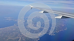 Wing of an airplane flying above the morning clouds plane wing airplane Wing of an airplane flying above the clouds. people looks