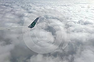 a wing of a boeing 737 plane above the clouds