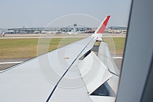 wing on commercial plane take off from airport in Japan