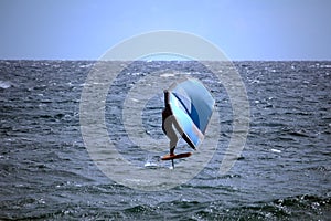 Wing foil a new watersport where the sail is carried with hands while standing on a board with hydrofoil