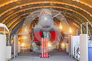 Wing military fighter with folded wings in the garage of the hangar on service repair