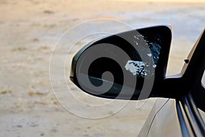 Wing mirror of a car with warm light