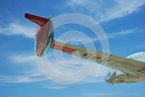 Wing of old jet in flight