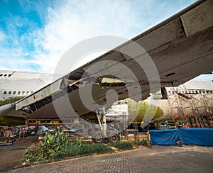 Wing of Salvage Aircraft. Airplane Being Remove of Its Metal Part for Resale in Boneyard. photo
