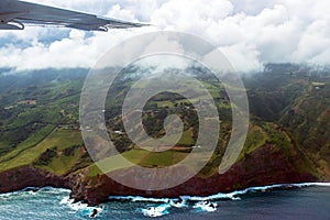 Wing of a small plane over the coast of Maui in Hawaii